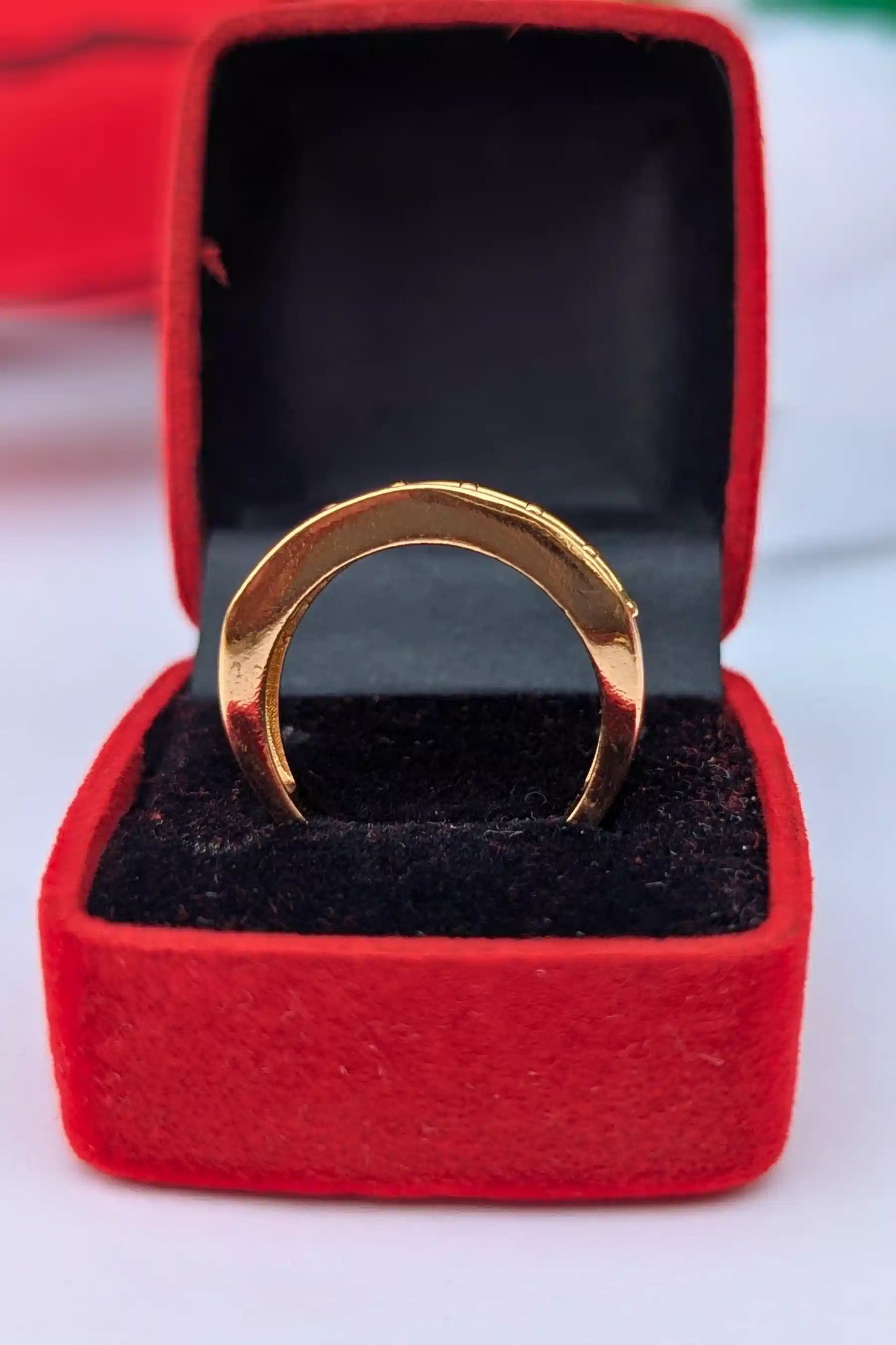 Gold ring in a red jewelry box