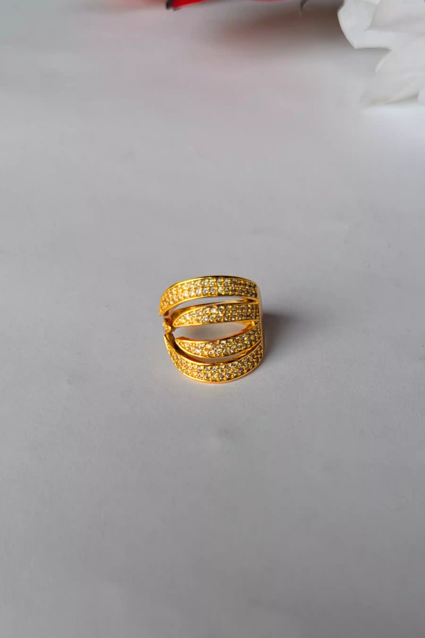 Gold ring on a light gray background