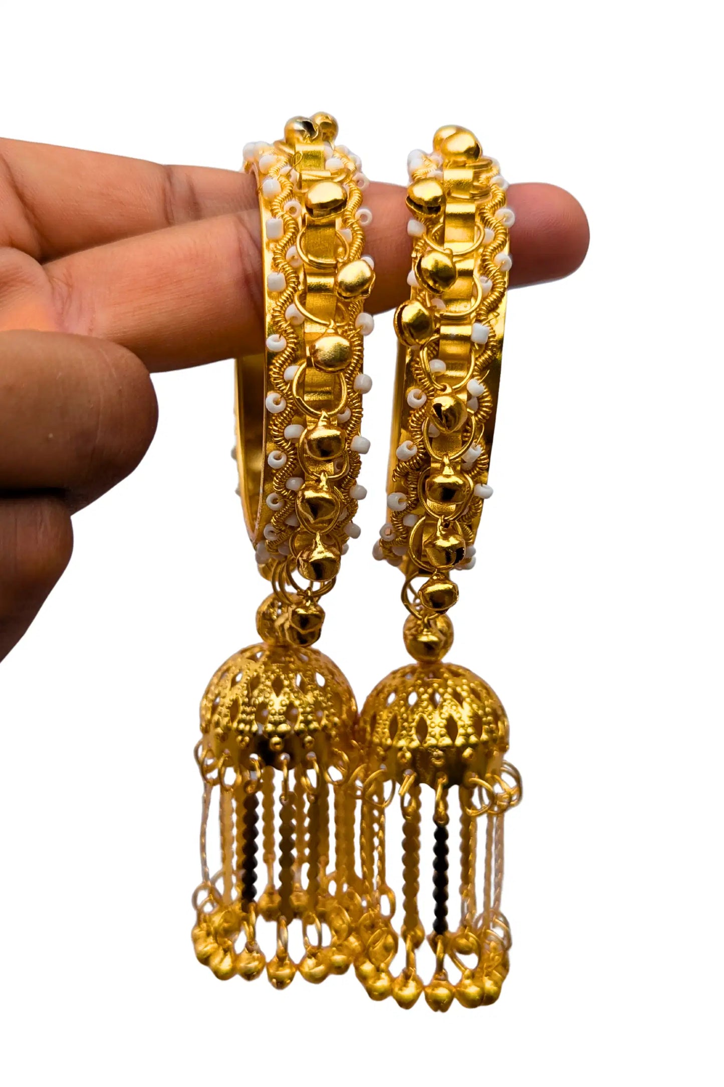 golden latkan bangles, jhumka bangle in a hand
