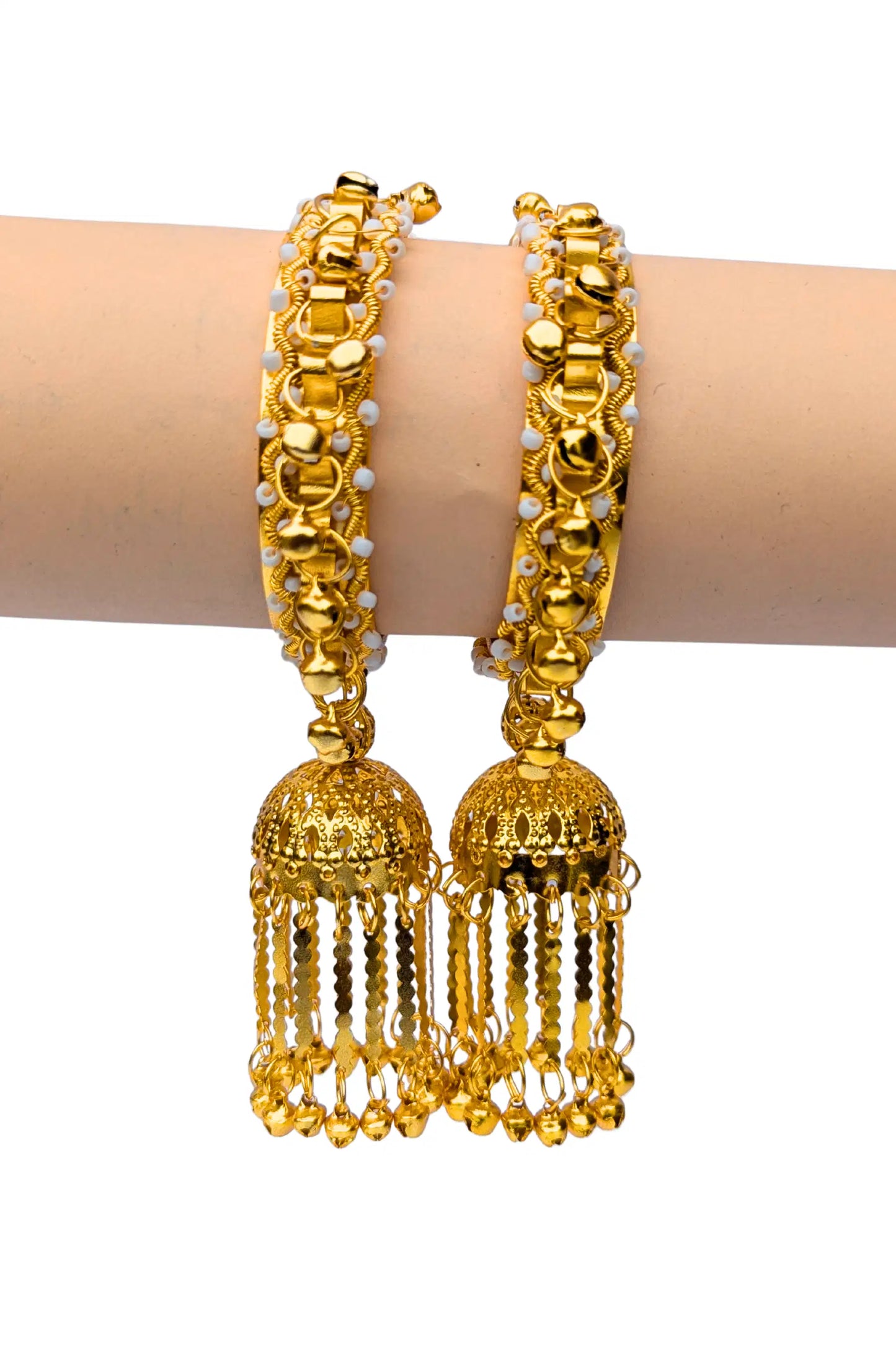 Gold bangles with tassels on a white background