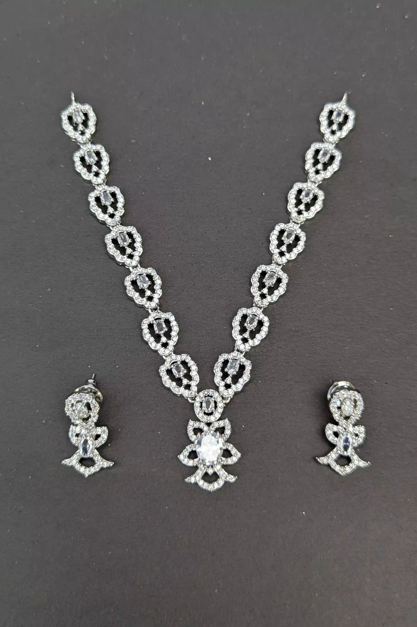 Jewelry set with necklace and earrings on a dark background