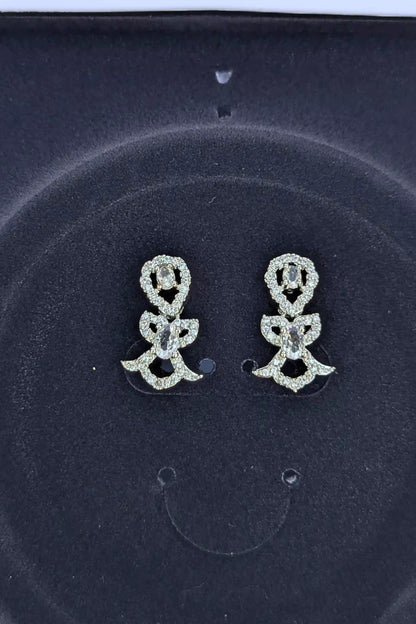 Pair of silver flower-shaped earrings on a dark background