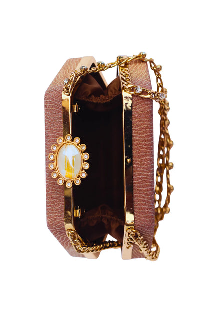 Golden brown bridal clutch bag with decorative clasp on a white background