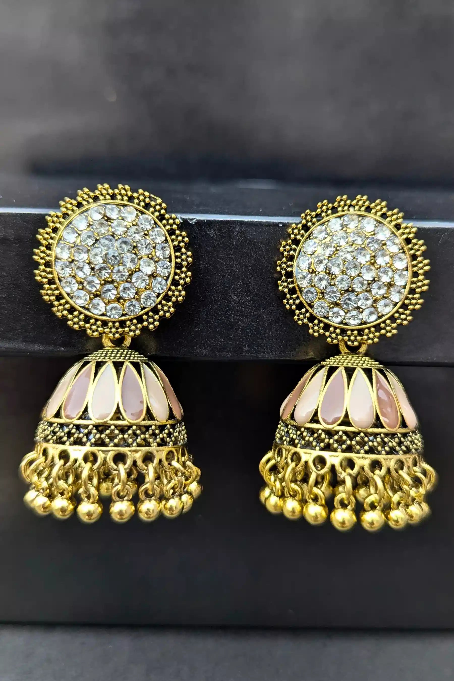 Gold and crystal earrings on a black background