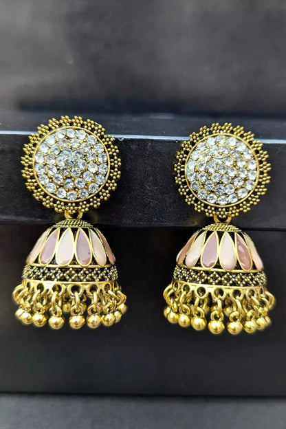 Gold and crystal earrings on a black background