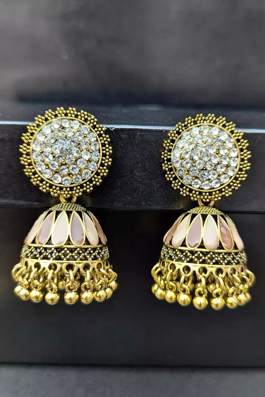 Gold and crystal earrings on a black background