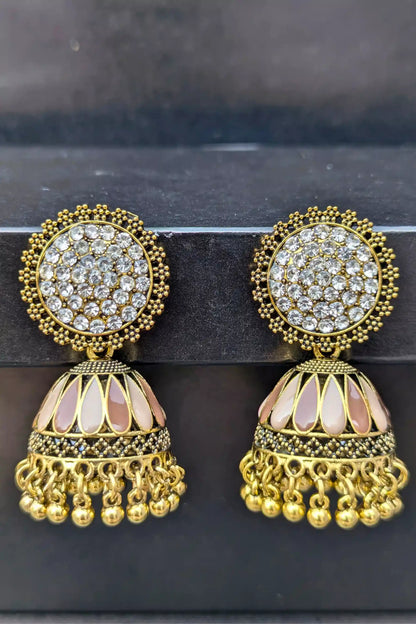 Pair of gold and crystal earrings on a dark background