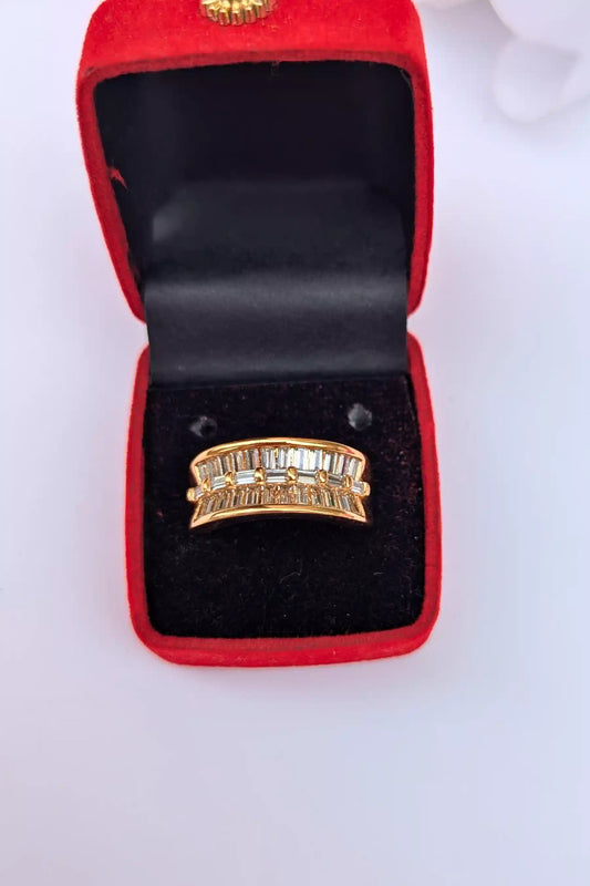 Golden ring in a red jewelry box on a white background