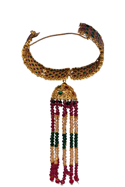 Decorative karra with tassel beads and gemstones on a white background