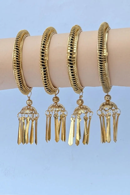 Set of gold hoop earrings with tassel details on a light blue background