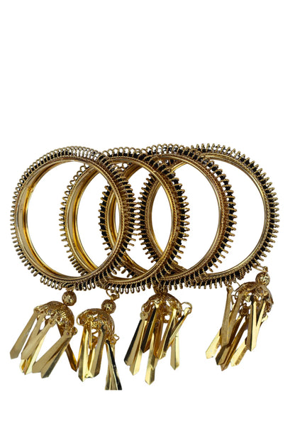 Set of gold bangles with tassels on a white background