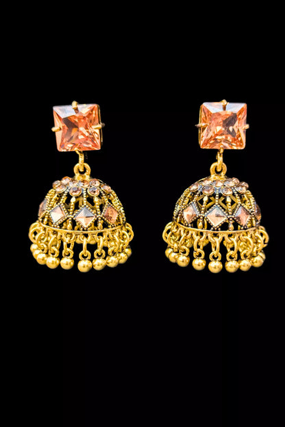 Gold earrings with champagne gemstones on a black background