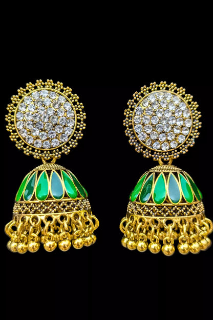 Gold earrings with green stones on a black background