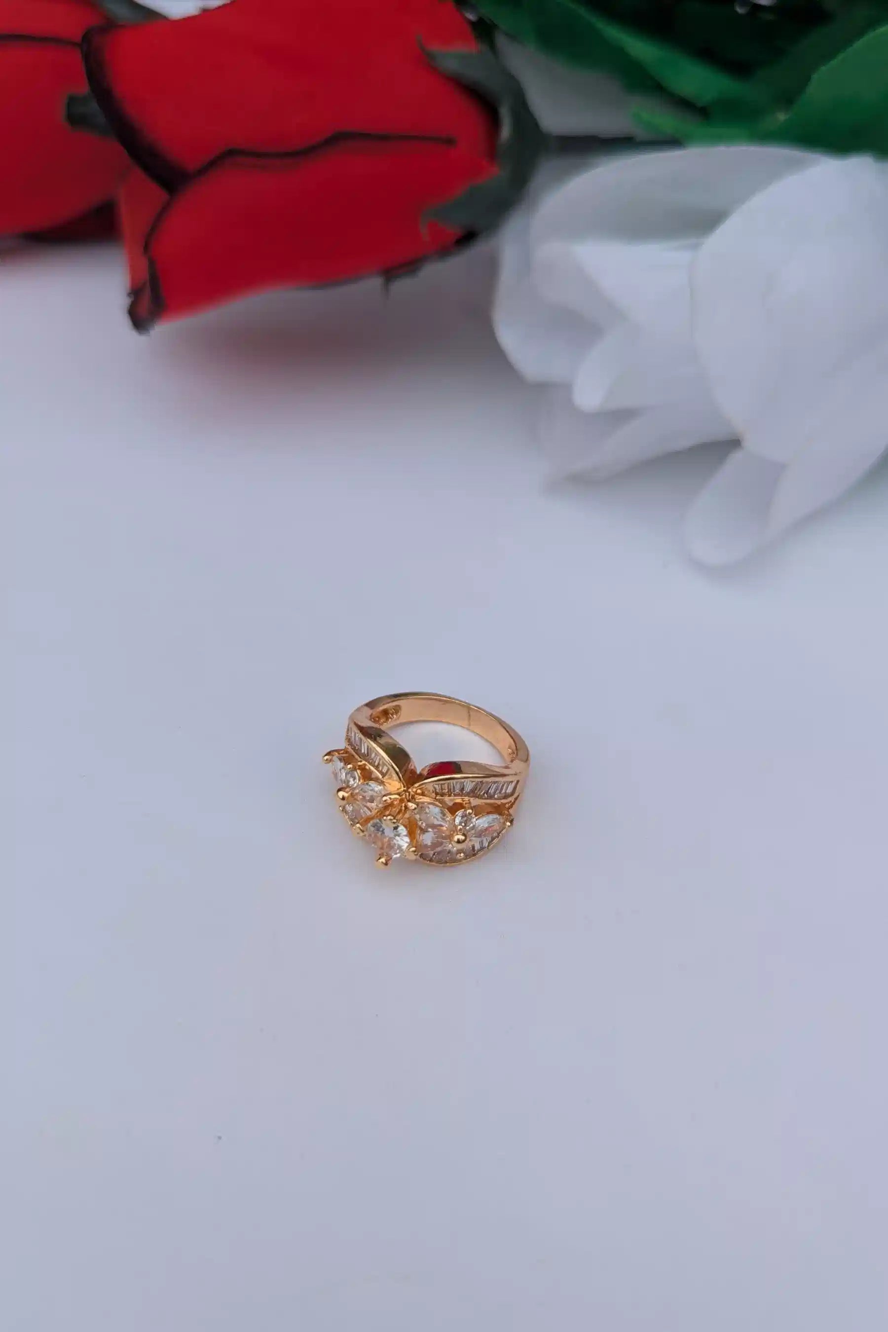 Gold ring with gemstones on a white background