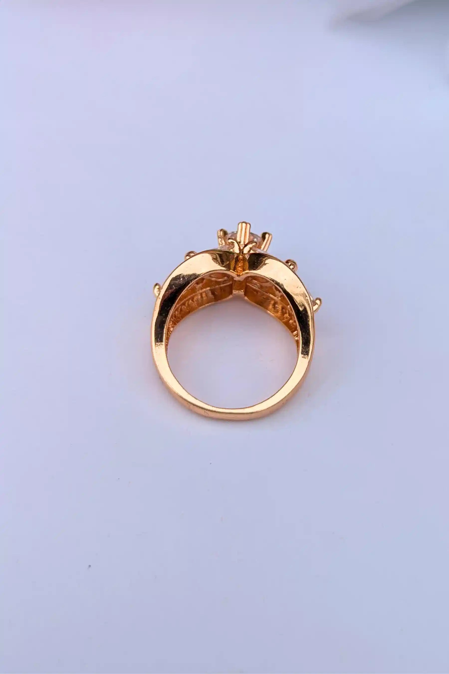 Gold ring with a diamond on a light blue background