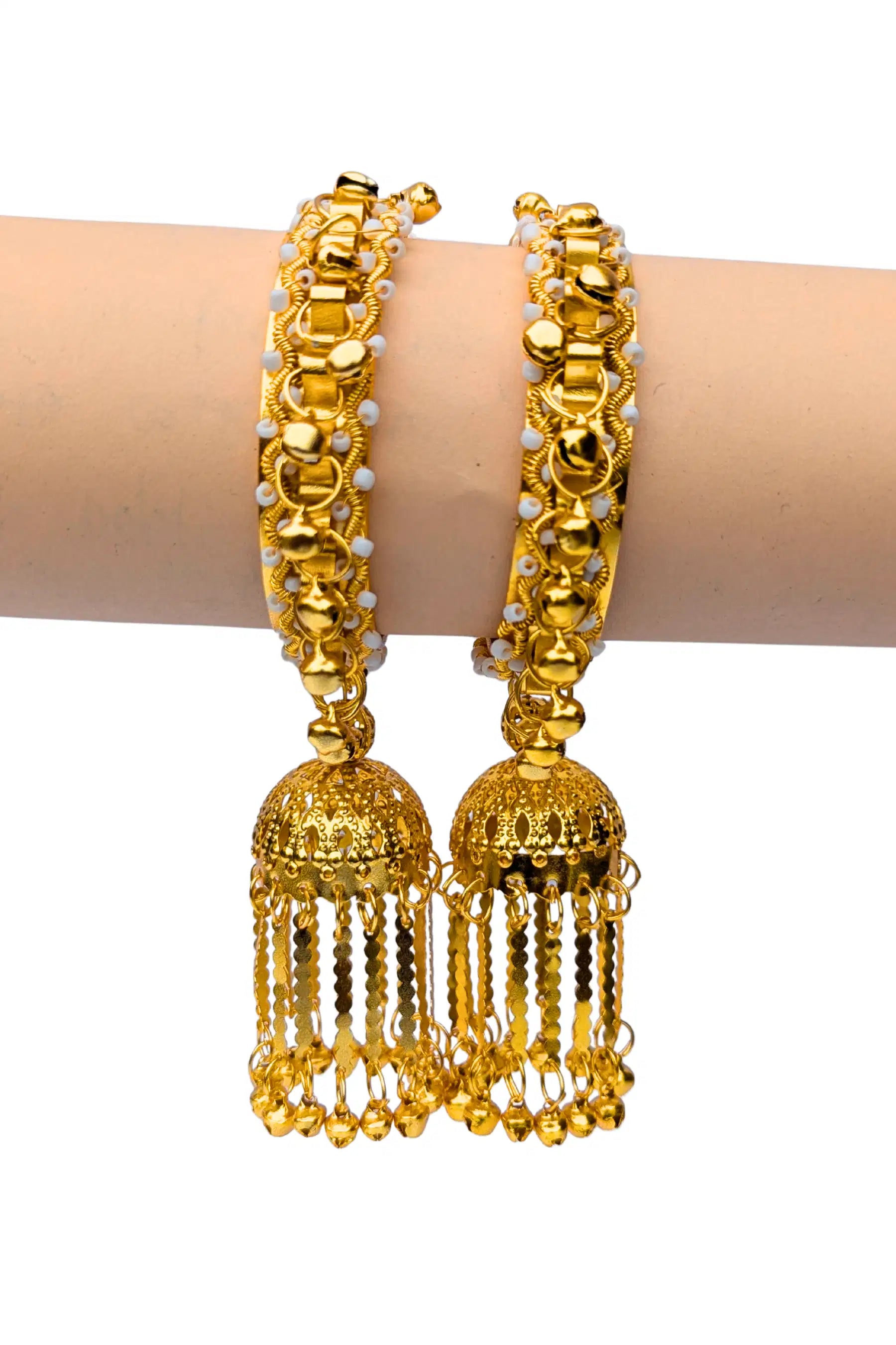 Gold bangles with tassels on a white background