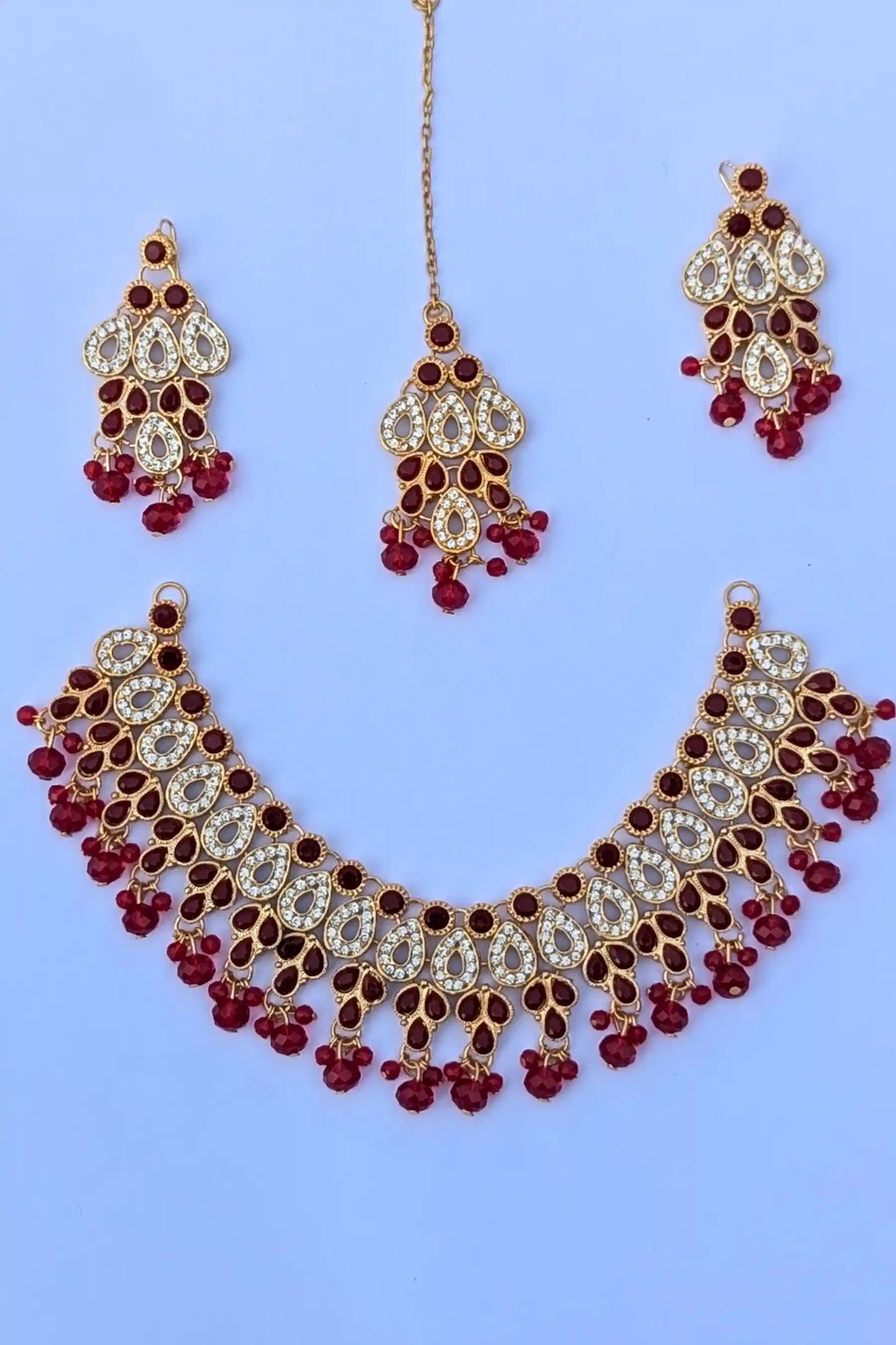 Jewelry set with necklace and earrings on a light blue background