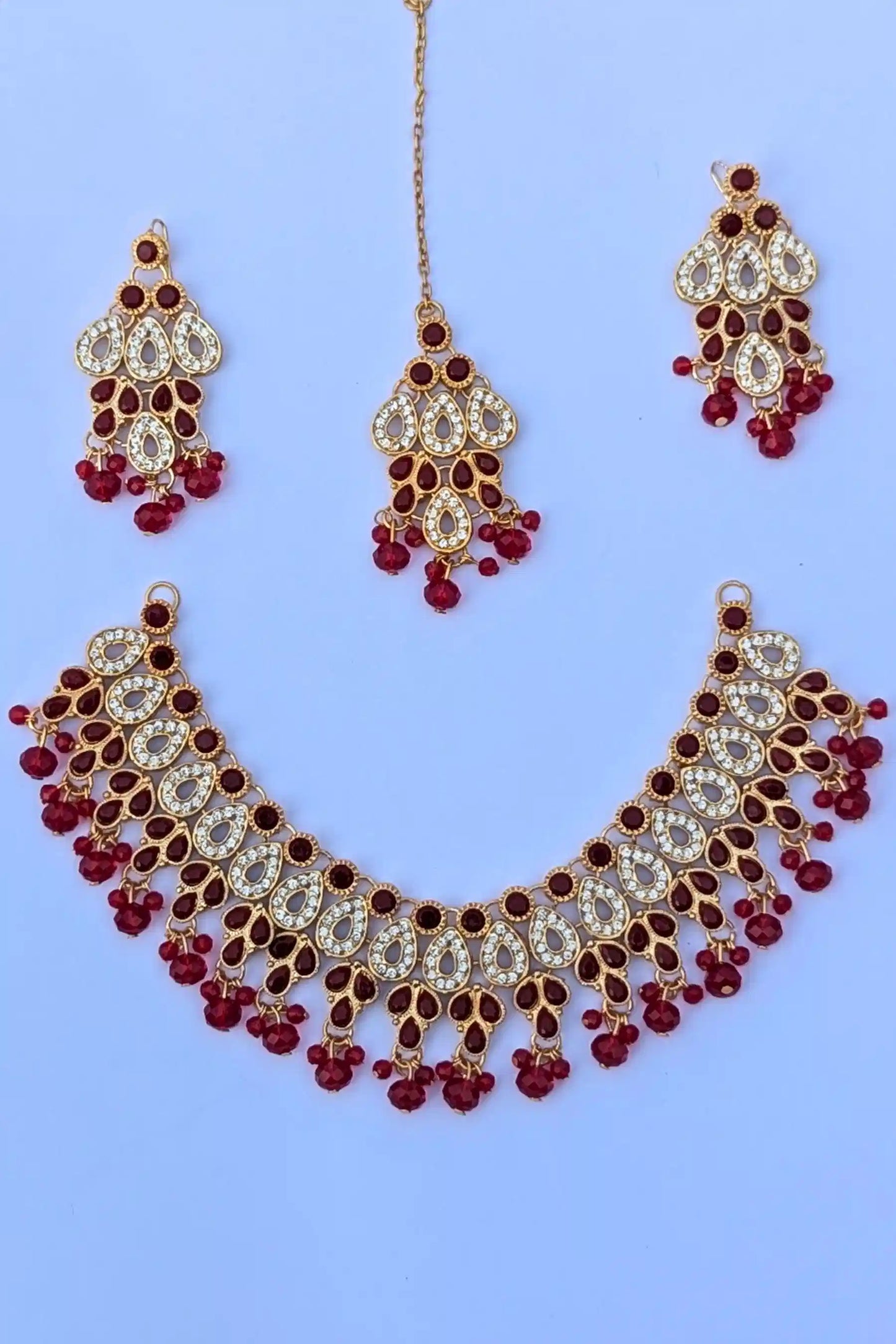 Jewelry set with necklace, earrings, and hairpins on a blue background
