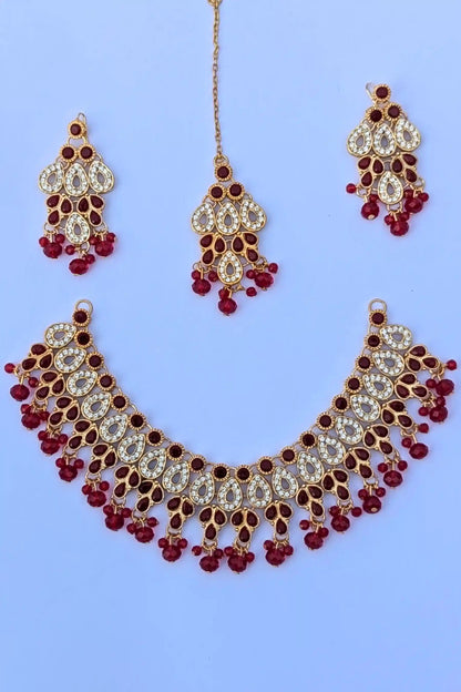 Jewelry set with necklace, earrings, and hairpins on a blue background