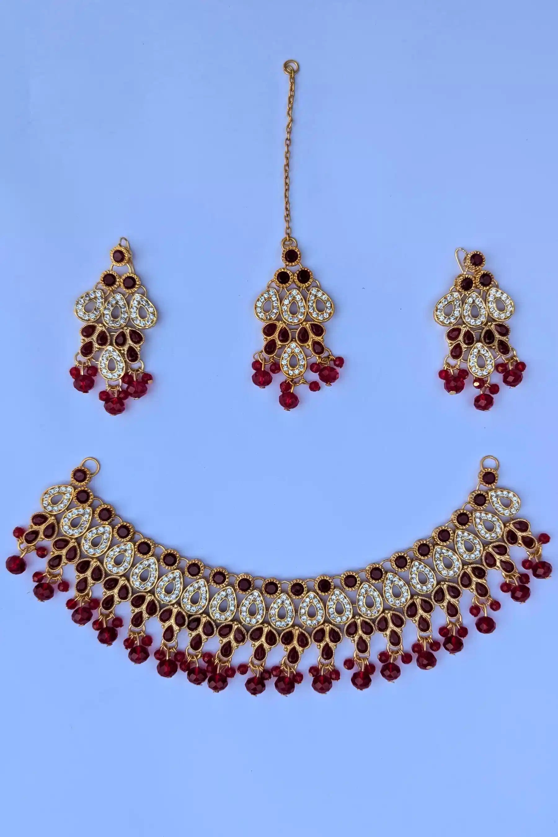 Jewelry set with necklace, earrings, and hairpin on a blue background