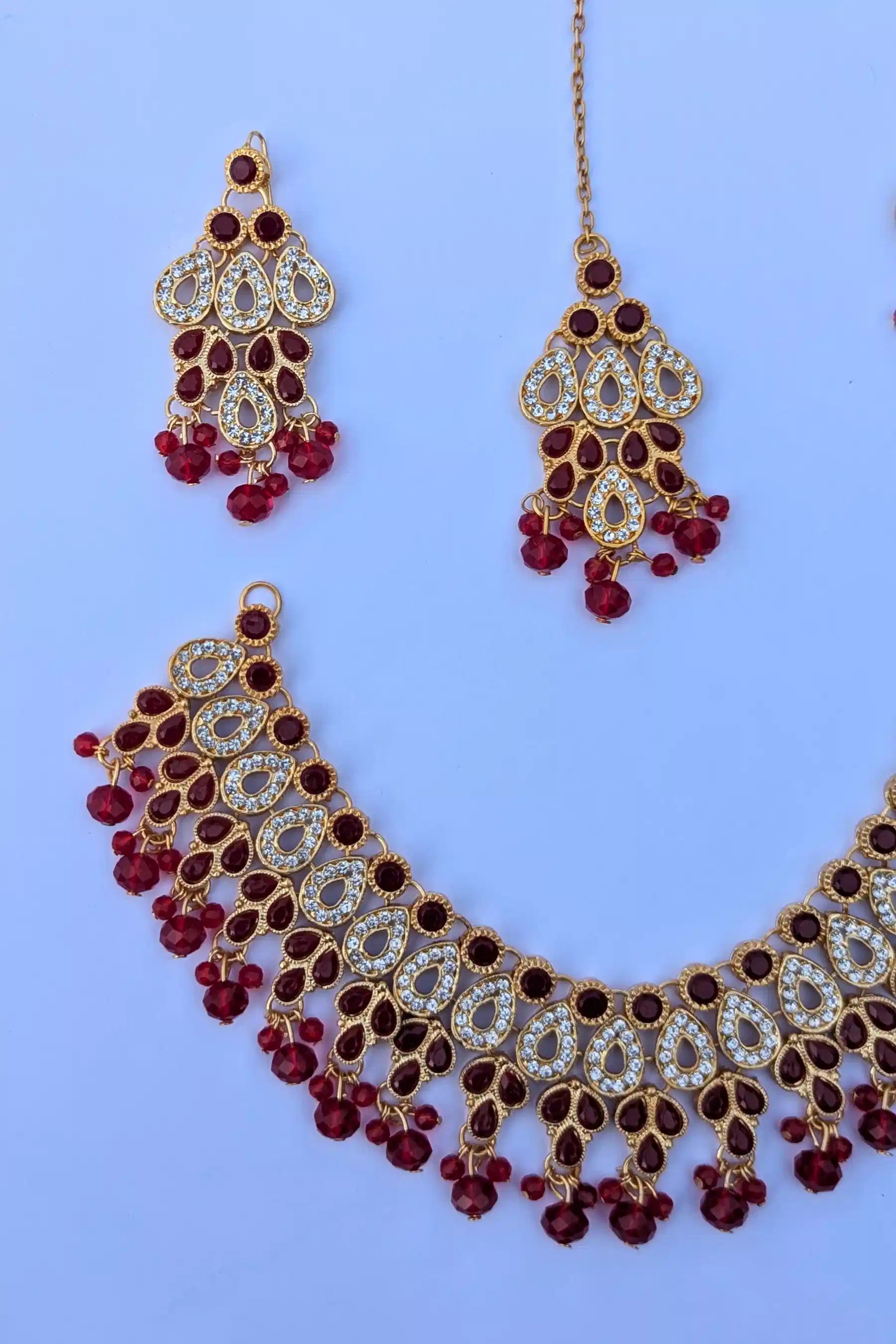 Jewelry set with necklace and earrings on a light blue background