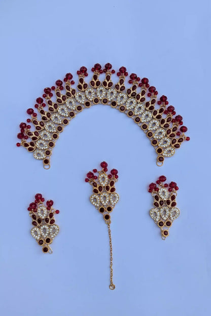 Set of jewelry including a headpiece, hairpin, and earrings on a blue background