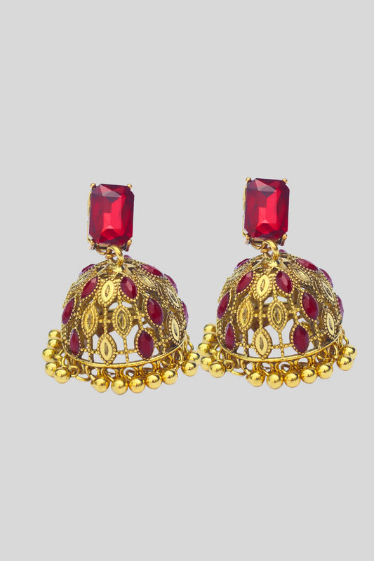 Gold and red earrings on a light gray background