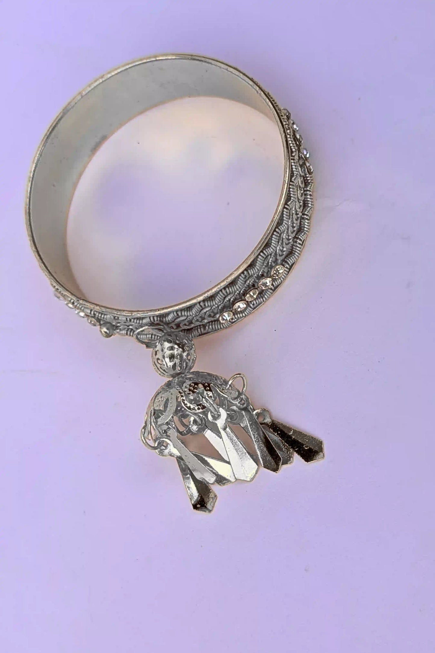 Decorative karra ring on a light purple background