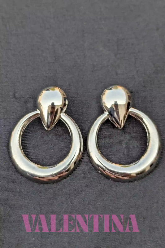Pair of silver  hoop earrings on a dark background with 'Valentina' branding.