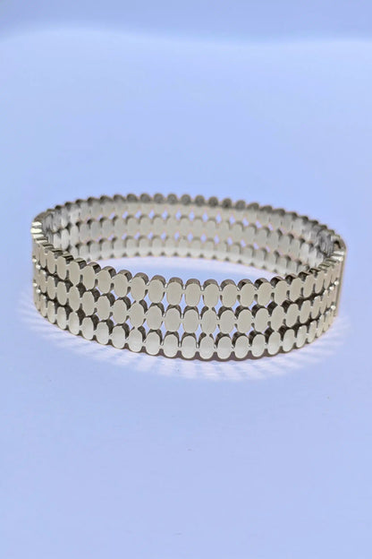 Silver bracelet on a light blue background