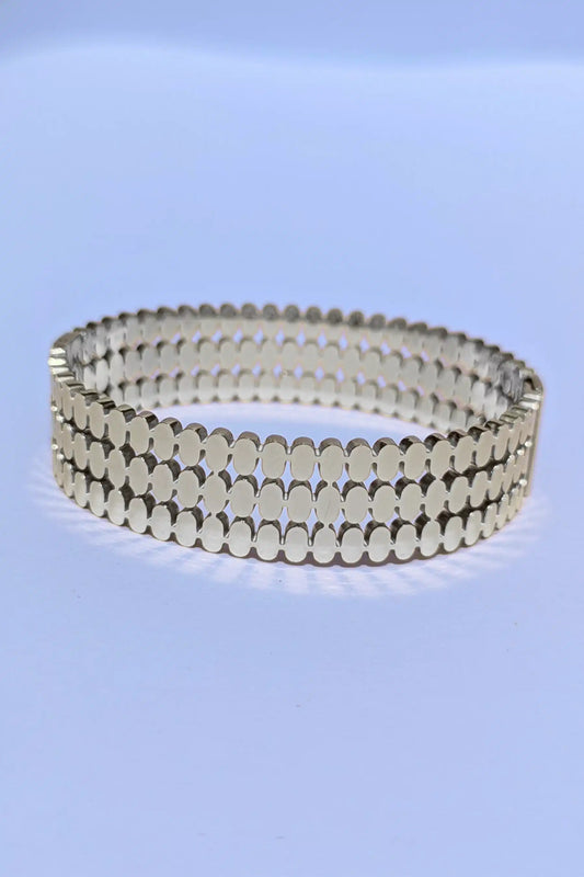 Silver bracelet on a light blue background