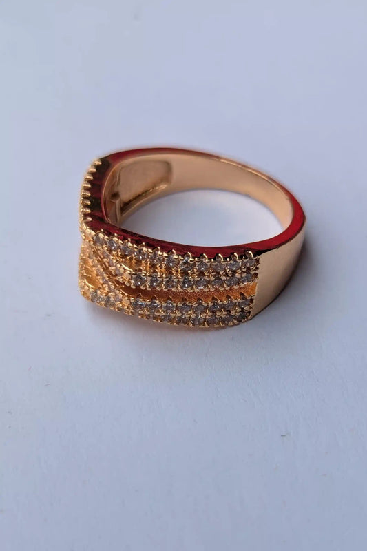 Gold and red ring on a light gray background