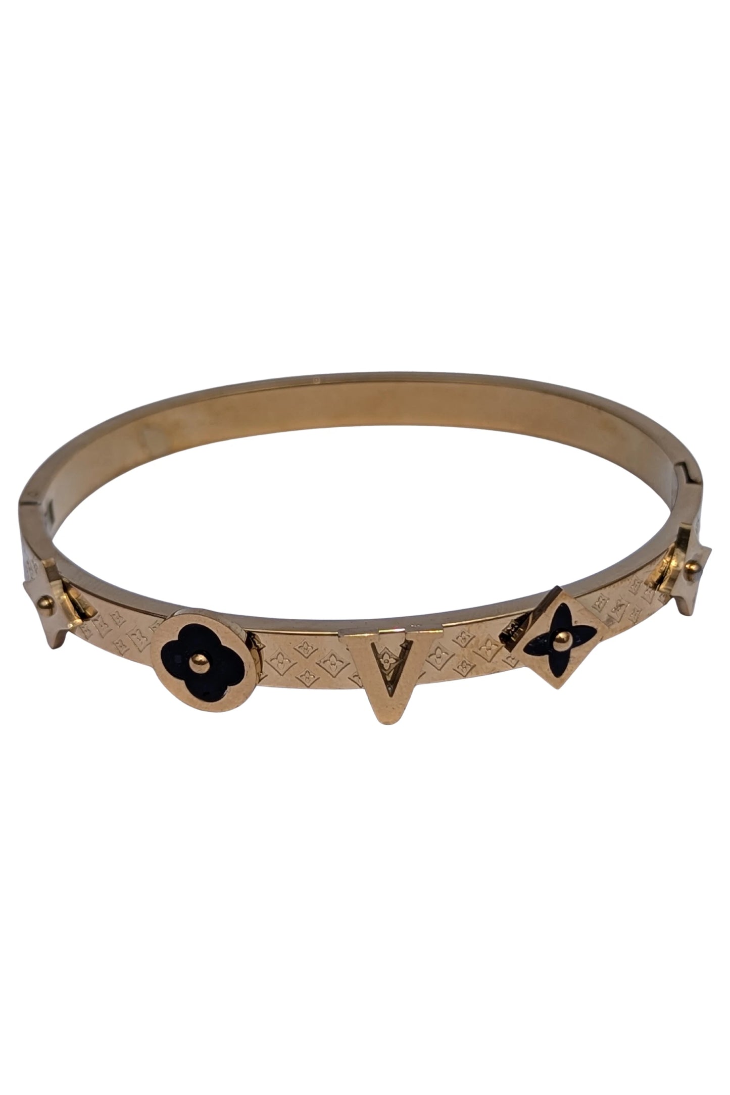 Gold bracelet with black flower designs on a white background