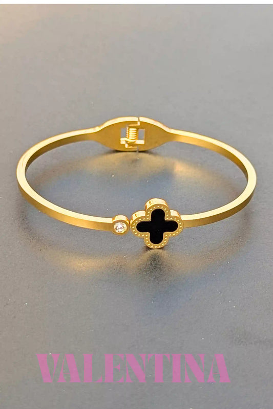 Gold bracelet with a black clover design on a gray background, featuring the brand 'Valentina'.
