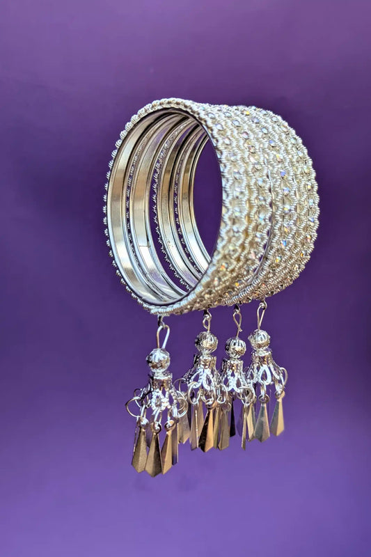 Decorative bangles with tassels on a purple background