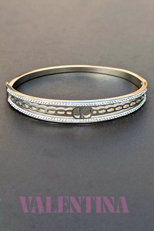 Silver bracelet with decorative patterns on a dark background, branded 'Valentina'.