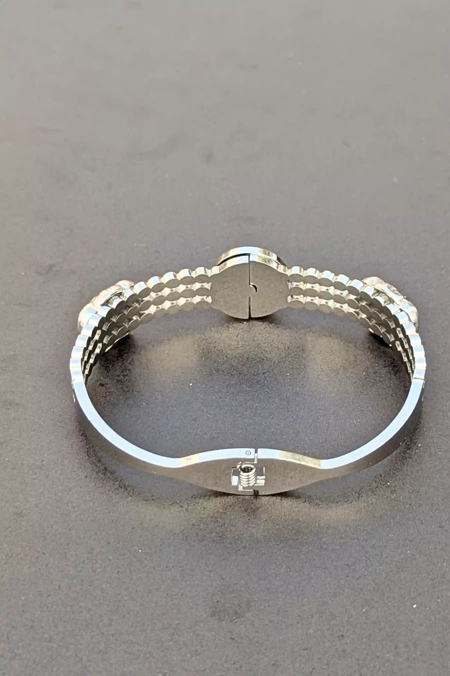 Silver bracelet on a gray background