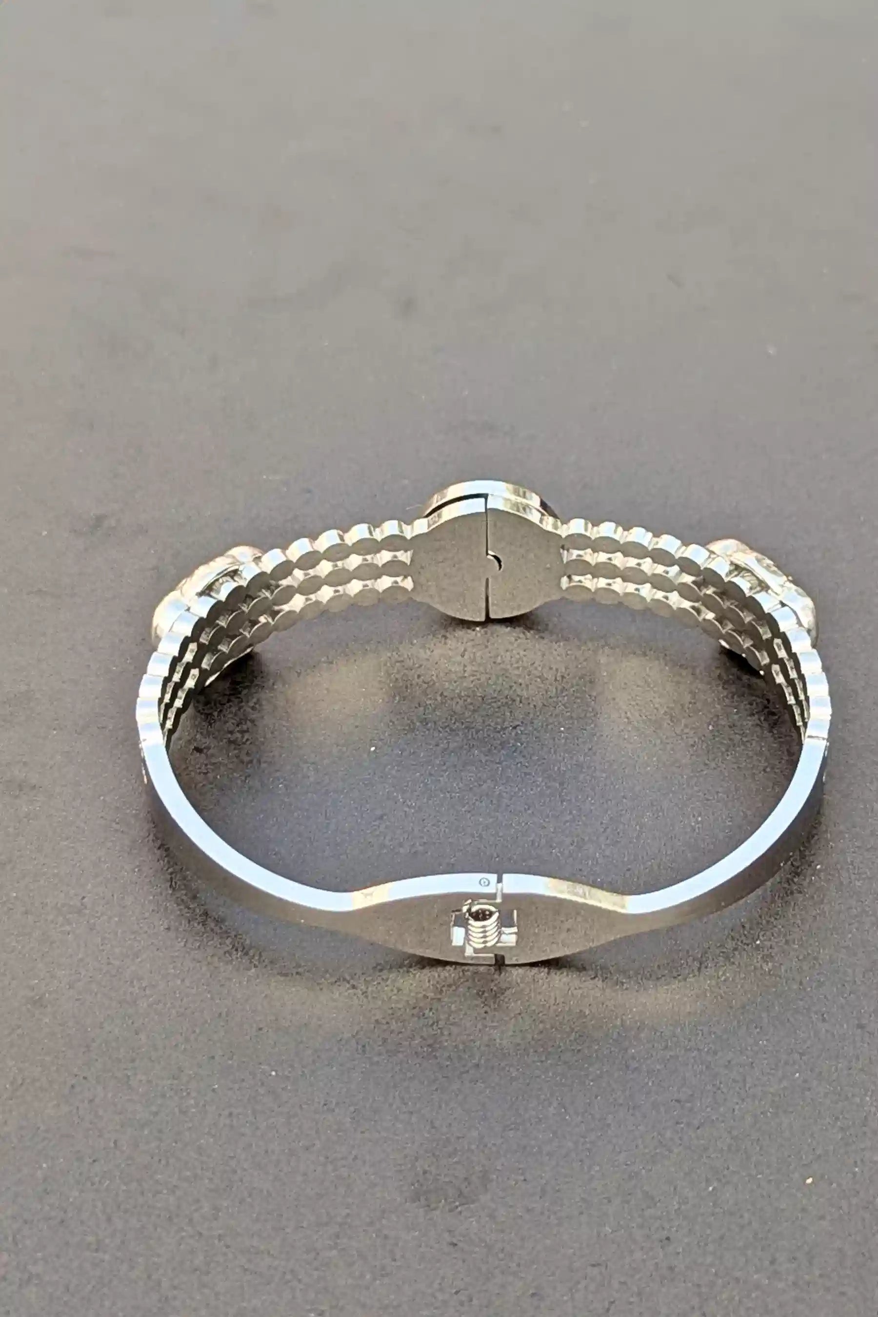 Silver bracelet on a gray background
