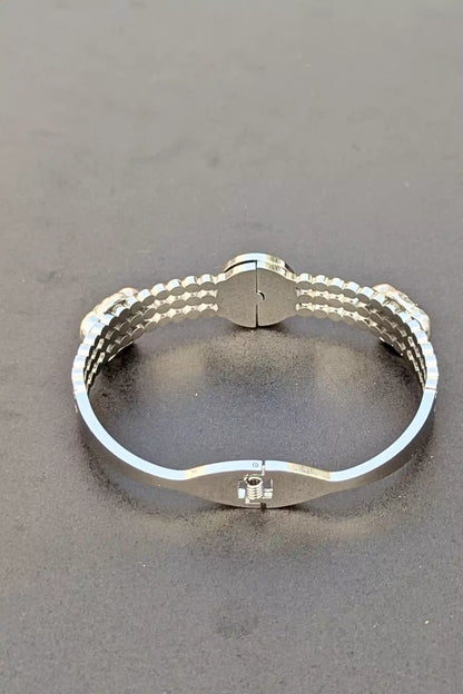 Silver bracelet on a gray background